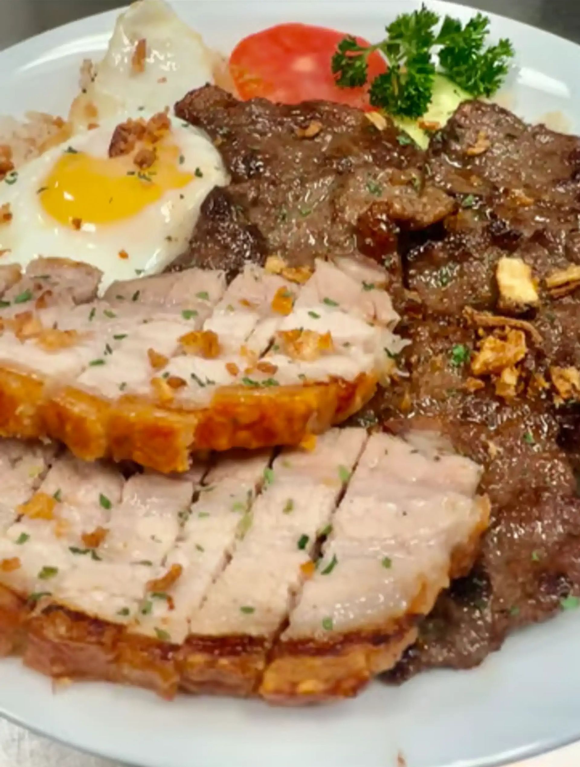 Tapsi/Crispy Combo at Archie's Grill - Tender striploin beef and super crispy pork belly with rice and egg